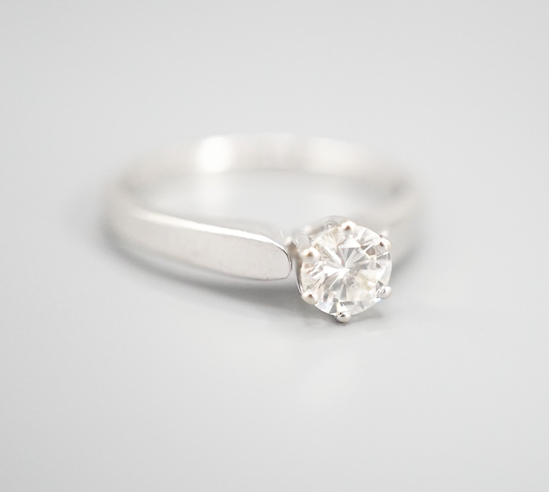 A modern white metal and solitaire diamond ring, size M, gross weight 2.3 grams.